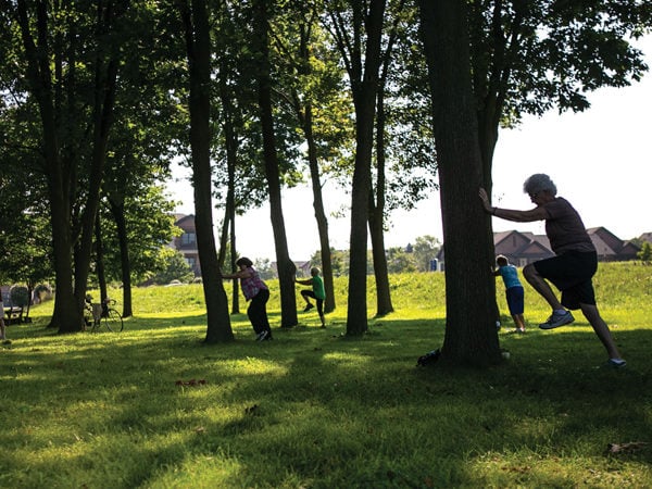 Seniors exercising outdoors by trees