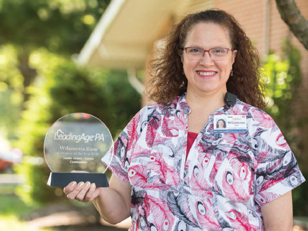 Employee holding up her award