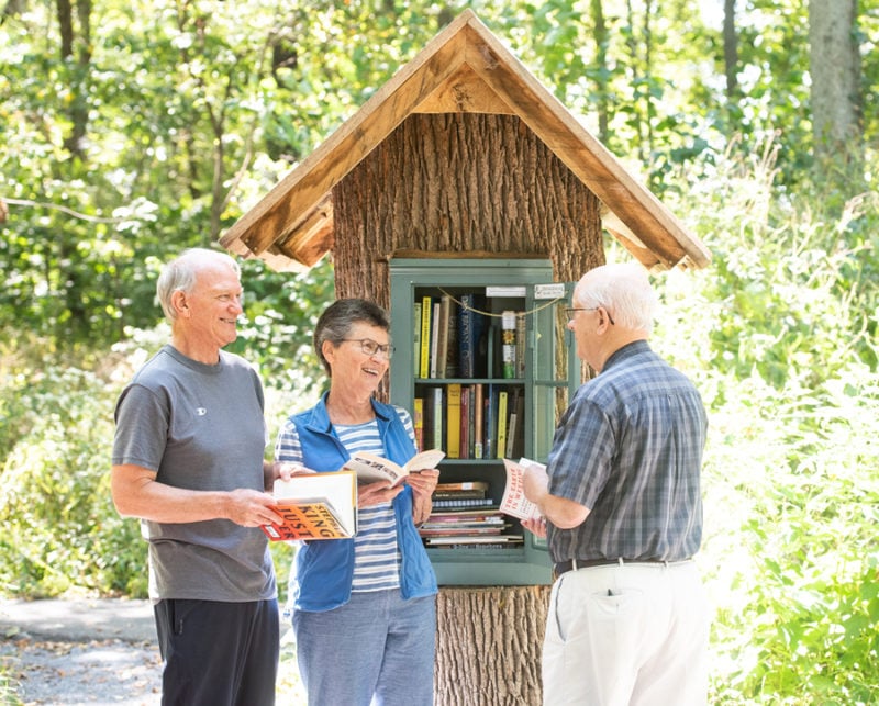 Residents with books outdoors