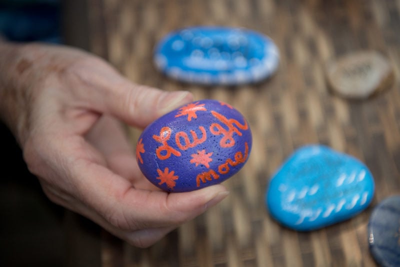 The words laugh more painted on a rock