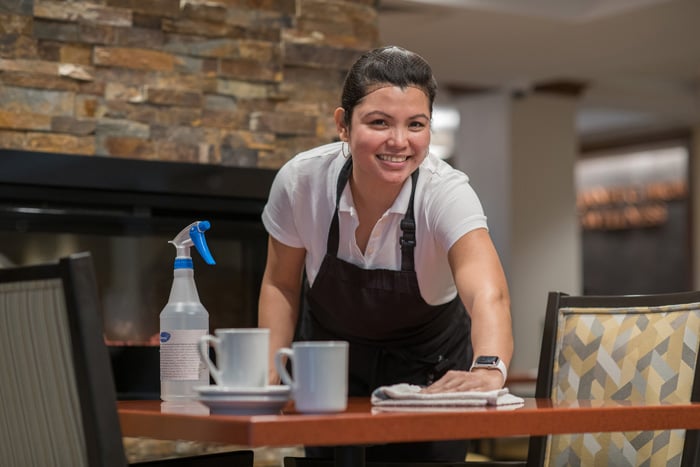 Woman cleaning dinner table