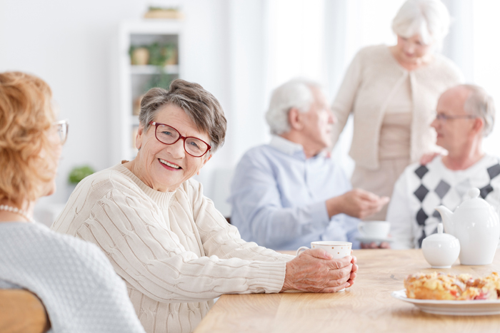 Woman drinking coffee with friends.