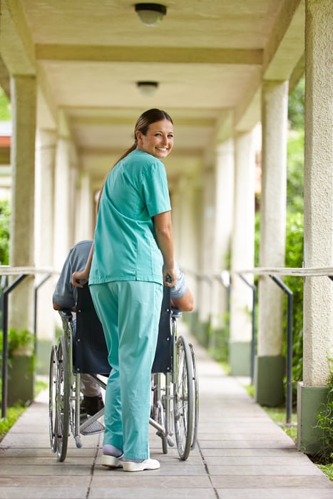 Staff member pushing a resident in wheelchair