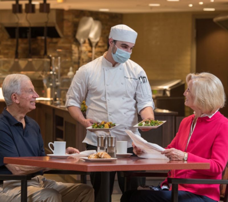 chef serving residents dinner