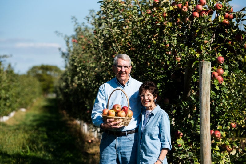 Man and woman in apple orchard