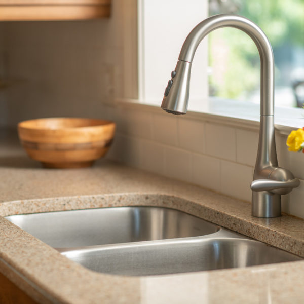 Kitchen sink with flowers in vase