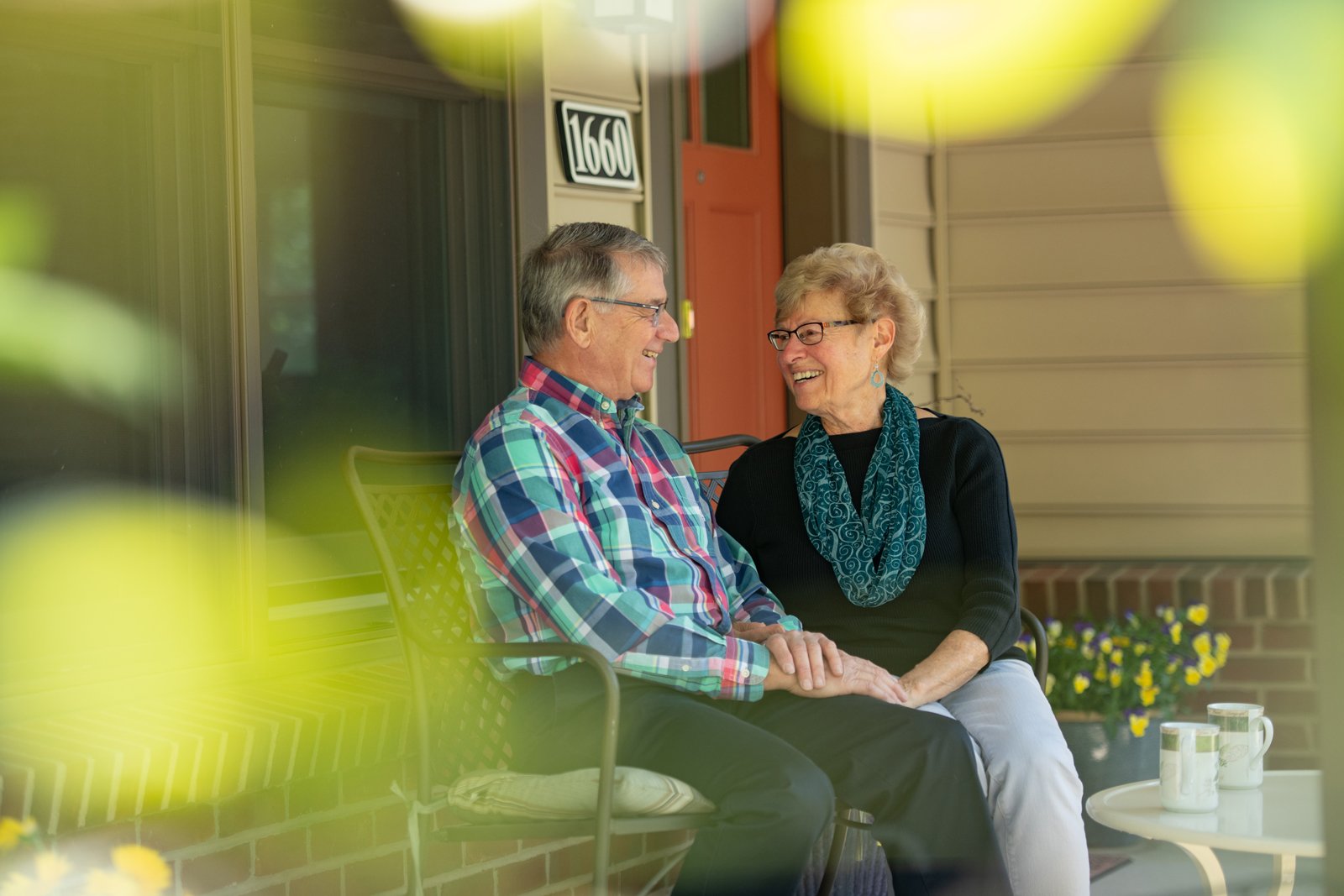 Two residents outdoors holding hands
