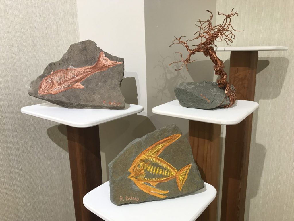 Rocks painted with fish designs. 