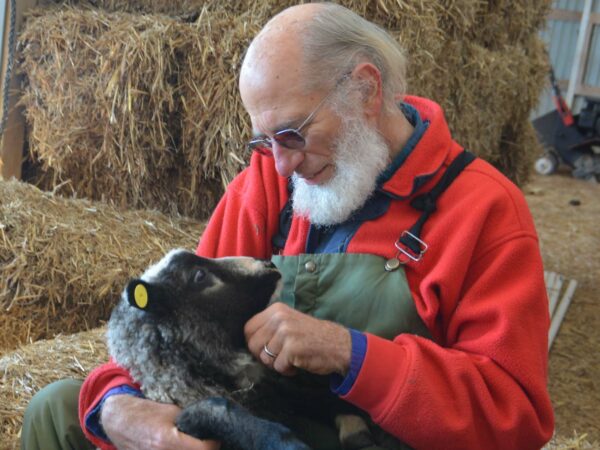 A man holding a lamb.