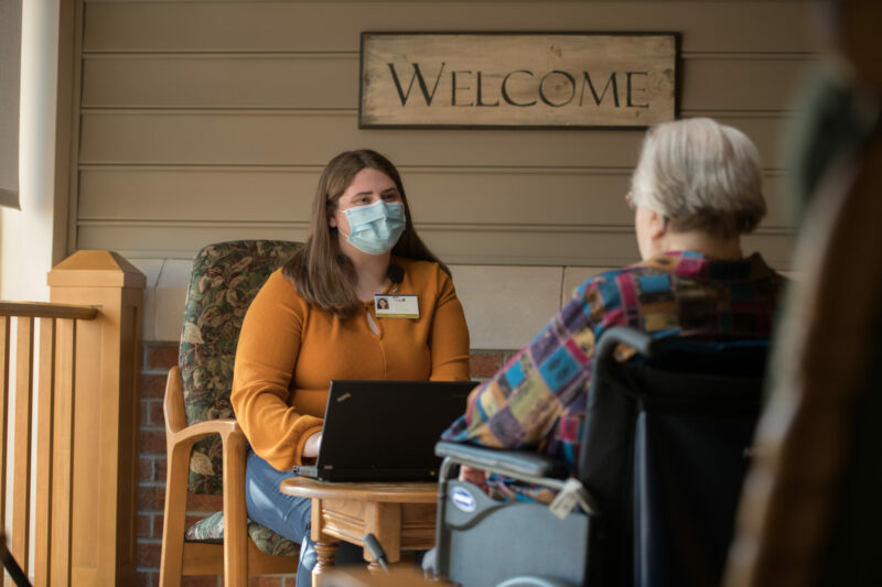 Landis Homes resident having a conversation with a nurse.