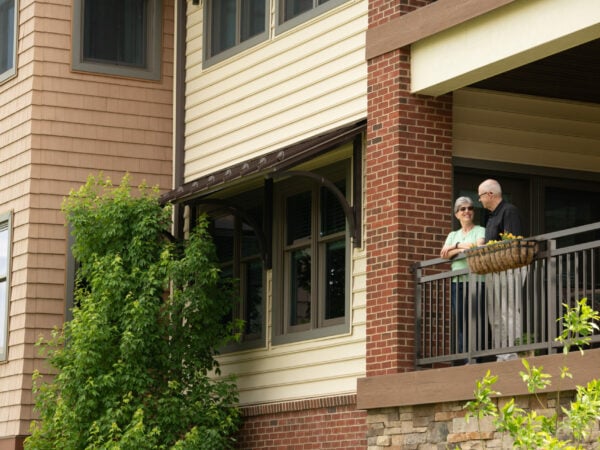 Residents enjoying the view from a balcony.