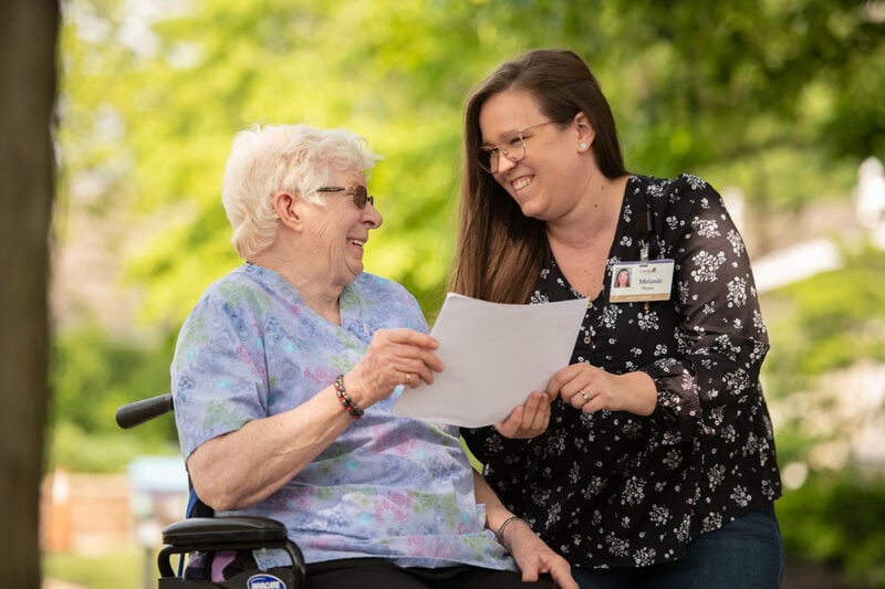 Personal care staff member having a pleasant conversation with a resident.