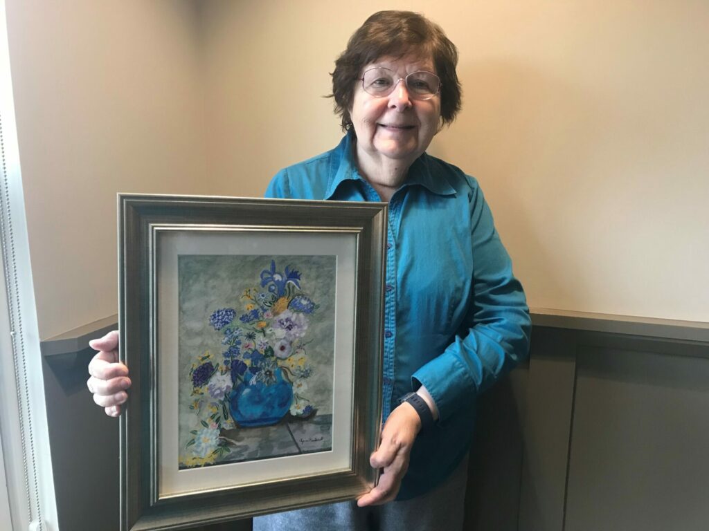 Agnes Handerk holding one of her art pieces. 