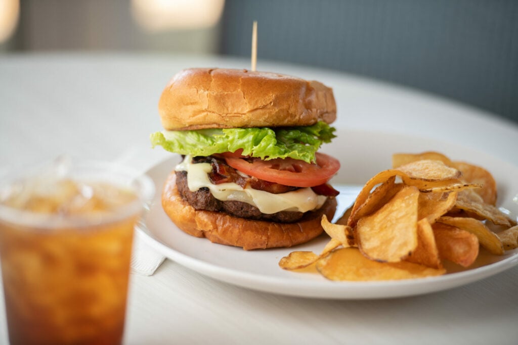 A cheeseburger and potato chips.