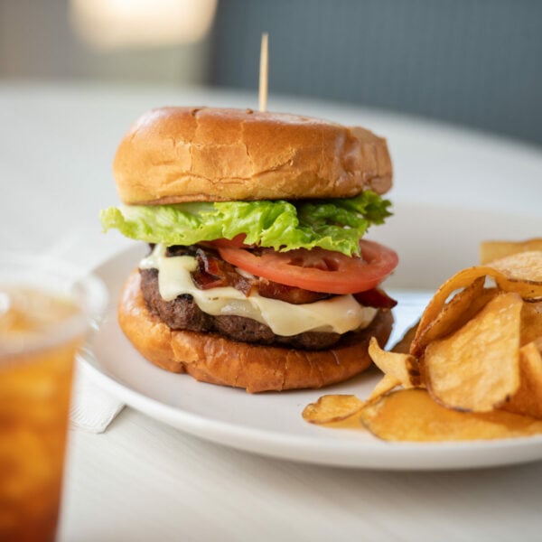 A cheeseburger and potato chips.